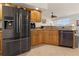 Stainless steel appliances and wood cabinets in kitchen at 2210 Bengal Ct, Punta Gorda, FL 33983