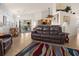 Living room features a brown leather couch and colorful rug at 2210 Bengal Ct, Punta Gorda, FL 33983