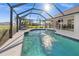 Sparkling pool with screened enclosure and patio furniture at 2210 Bengal Ct, Punta Gorda, FL 33983