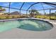 Inviting kidney-shaped pool, screened for privacy at 2210 Bengal Ct, Punta Gorda, FL 33983