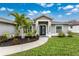 Landscaped front yard with walkway leading to modern front door at 2380 Ann Arbor Rd, North Port, FL 34286