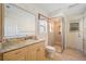 Bathroom with granite countertop vanity, shower, and toilet at 2427 St Davids Island Ct, Punta Gorda, FL 33950