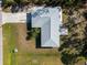 Aerial view of a light teal house with a gray roof and spacious yard at 2529 Flagami Ln, North Port, FL 34286