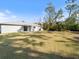 Spacious backyard with grassy lawn, providing ample outdoor space at 2529 Flagami Ln, North Port, FL 34286