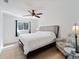 Main bedroom with a king-size bed, light flooring, and a ceiling fan at 2529 Flagami Ln, North Port, FL 34286