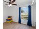 bedroom with stacked gymnastic mats and a large window at 2529 Flagami Ln, North Port, FL 34286