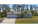 Single story house with a two-car garage and a well-maintained lawn at 2529 Flagami Ln, North Port, FL 34286