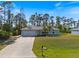 House front with a driveway and well-maintained lawn at 2529 Flagami Ln, North Port, FL 34286