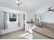 Bright kitchen with white cabinets, wood-look floors, and a window overlooking the backyard at 2529 Flagami Ln, North Port, FL 34286