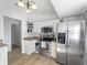 Bright kitchen, stainless steel appliances, white cabinets, and light wood flooring at 2529 Flagami Ln, North Port, FL 34286