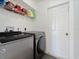 Well-lit laundry room, featuring a washer and dryer and ample shelving at 2529 Flagami Ln, North Port, FL 34286