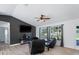 Bright living room featuring hardwood floors, large windows, and comfortable seating at 2529 Flagami Ln, North Port, FL 34286