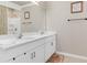 Bathroom with double vanity, large mirror, and shower at 25361 E Lenox Cir, Punta Gorda, FL 33950