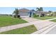 Light blue house with driveway and landscaping at 25361 E Lenox Cir, Punta Gorda, FL 33950