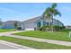 Light blue house with a two-car garage and palm trees at 25361 E Lenox Cir, Punta Gorda, FL 33950