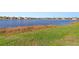 Scenic view of a tranquil lake with homes in the background at 25361 E Lenox Cir, Punta Gorda, FL 33950