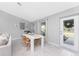 Bright dining area with white table and natural wood chairs at 25896 Prada Dr, Punta Gorda, FL 33955