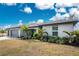 House front view, showcasing landscaping, walkway, and two-car garage at 25896 Prada Dr, Punta Gorda, FL 33955