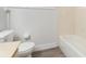 Simple bathroom with a toilet, bathtub and wood-look floors at 26316 Nadir Rd # A2, Punta Gorda, FL 33983