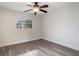 Spacious bedroom featuring wood-look floors and ceiling fan at 26316 Nadir Rd # A2, Punta Gorda, FL 33983