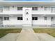 Condo building exterior featuring white walls and balconies at 26316 Nadir Rd # A2, Punta Gorda, FL 33983