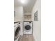 Laundry area with washer, dryer, and extra shelving at 26316 Nadir Rd # A2, Punta Gorda, FL 33983