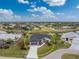 Aerial view of single-story house with driveway and canal view at 27072 Ecuador Dr, Punta Gorda, FL 33983