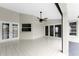 Spacious tiled back patio with double doors and ceiling fan at 27072 Ecuador Dr, Punta Gorda, FL 33983