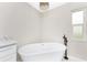 Relaxing bathroom with a freestanding soaking tub and chandelier at 27072 Ecuador Dr, Punta Gorda, FL 33983