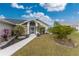 House exterior with a landscaped yard and walkway at 27072 Ecuador Dr, Punta Gorda, FL 33983