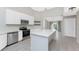 Modern kitchen with white cabinets, stainless steel appliances and an island at 27072 Ecuador Dr, Punta Gorda, FL 33983