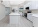 Modern kitchen featuring white cabinets, stainless steel appliances, and an island at 27072 Ecuador Dr, Punta Gorda, FL 33983