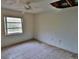 A bedroom with tile flooring and a window at 27446 Pasto Dr, Punta Gorda, FL 33983