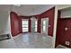 Bright dining area with burgundy walls and tile floors at 27446 Pasto Dr, Punta Gorda, FL 33983