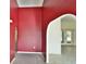 Bright red walls and arched entry to another room at 27446 Pasto Dr, Punta Gorda, FL 33983