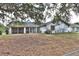 Backyard of a house with a screened-in porch and fenced yard at 27446 Pasto Dr, Punta Gorda, FL 33983