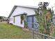 Side of house with screened porch and chain link fence at 27446 Pasto Dr, Punta Gorda, FL 33983