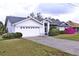 White house with gray roof, landscaping, and a two-car garage at 27446 Pasto Dr, Punta Gorda, FL 33983