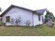 Side view of a house showing a window and landscaping at 27446 Pasto Dr, Punta Gorda, FL 33983