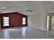 Spacious living room with tile flooring and a ceiling fan at 27446 Pasto Dr, Punta Gorda, FL 33983