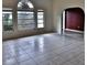 Spacious living room featuring tile floors and an arched entryway at 27446 Pasto Dr, Punta Gorda, FL 33983