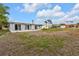 Spacious backyard with grassy area and a view of neighboring homes at 3112 Magnolia Way, Punta Gorda, FL 33950