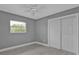 Bedroom with a window, ceiling fan, and double doors at 3112 Magnolia Way, Punta Gorda, FL 33950