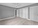 Spacious bedroom with grey walls, wood-look floors, and ample closet space at 3112 Magnolia Way, Punta Gorda, FL 33950