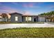 Charming gray house with a modern facade, well-manicured lawn, and a two-car garage at 3112 Magnolia Way, Punta Gorda, FL 33950