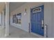 Inviting front porch with a navy blue door and white columns at 3112 Magnolia Way, Punta Gorda, FL 33950