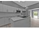 Modern kitchen island with white cabinets and a stainless steel sink at 3112 Magnolia Way, Punta Gorda, FL 33950