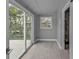 Laundry room with sliding glass door and wood-look tile at 3112 Magnolia Way, Punta Gorda, FL 33950