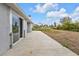 Large concrete patio with sliding glass doors at 3112 Magnolia Way, Punta Gorda, FL 33950