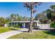 Gray house with a white fence and a large tree at 3214 Amanda St, Punta Gorda, FL 33950